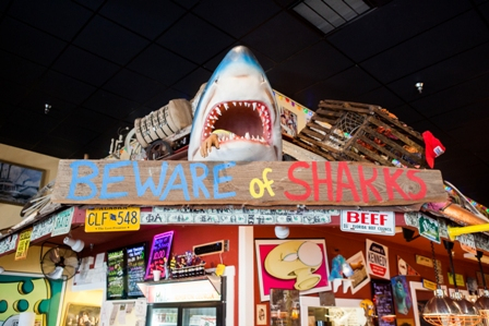 Beware of Sharks sign with shark jaws