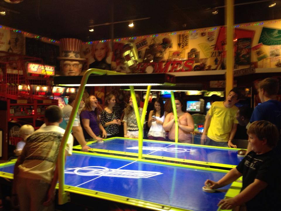 Teens playing air hockey at The Mill