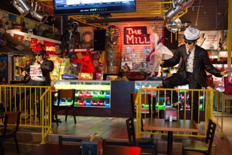 Blues Brothers figures flanking The Mill neon sign